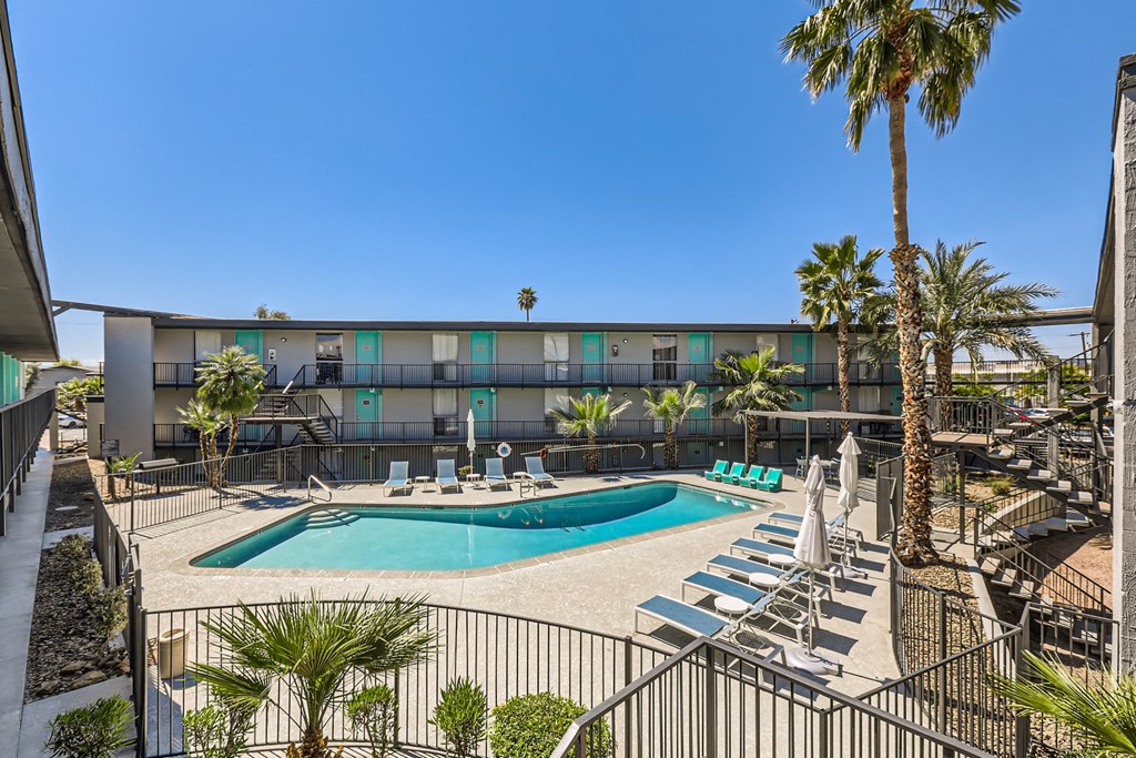a pool at a hotel with palm trees