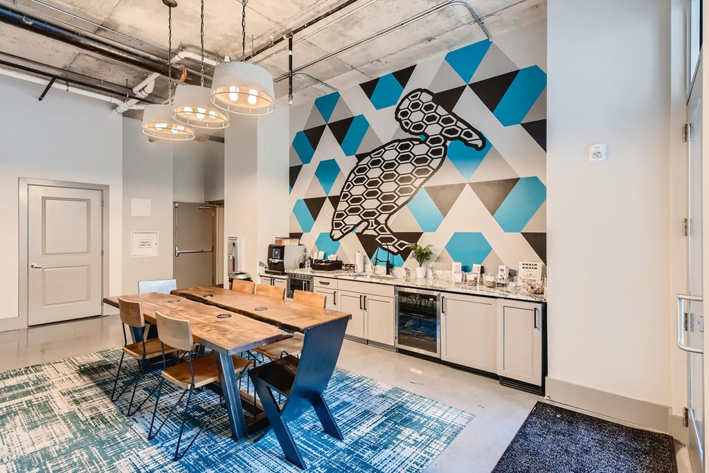 a dining room with a table and chairs and a mural on the wall