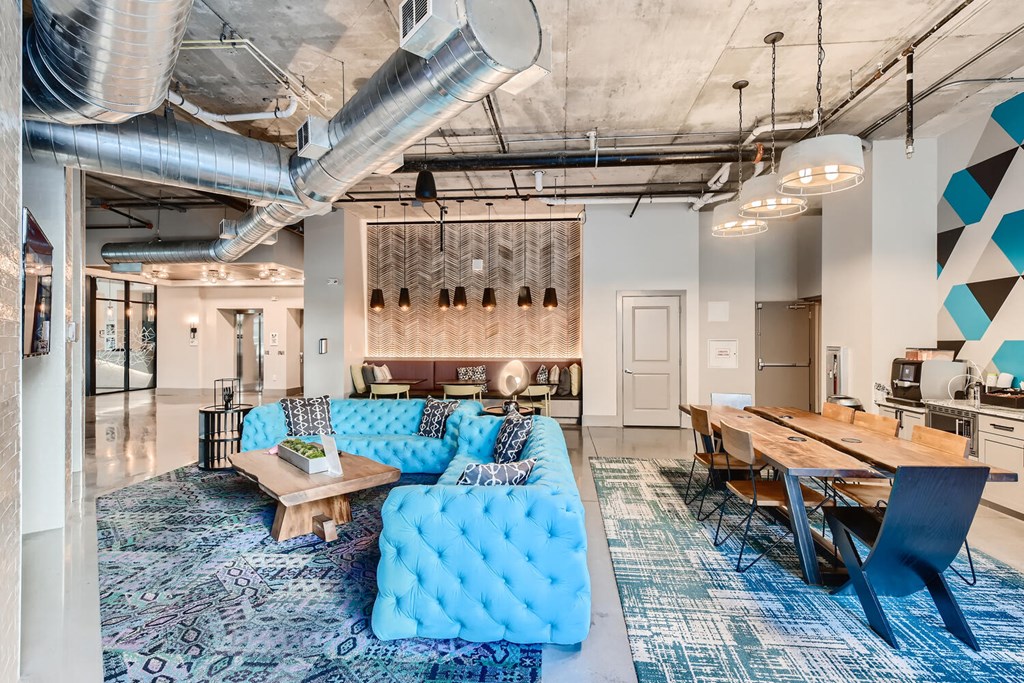 a living room with a blue couch and a table
