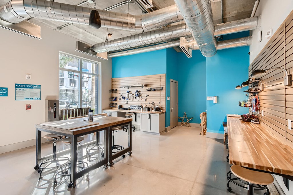 a tasting room with a table and a counter in front of a window