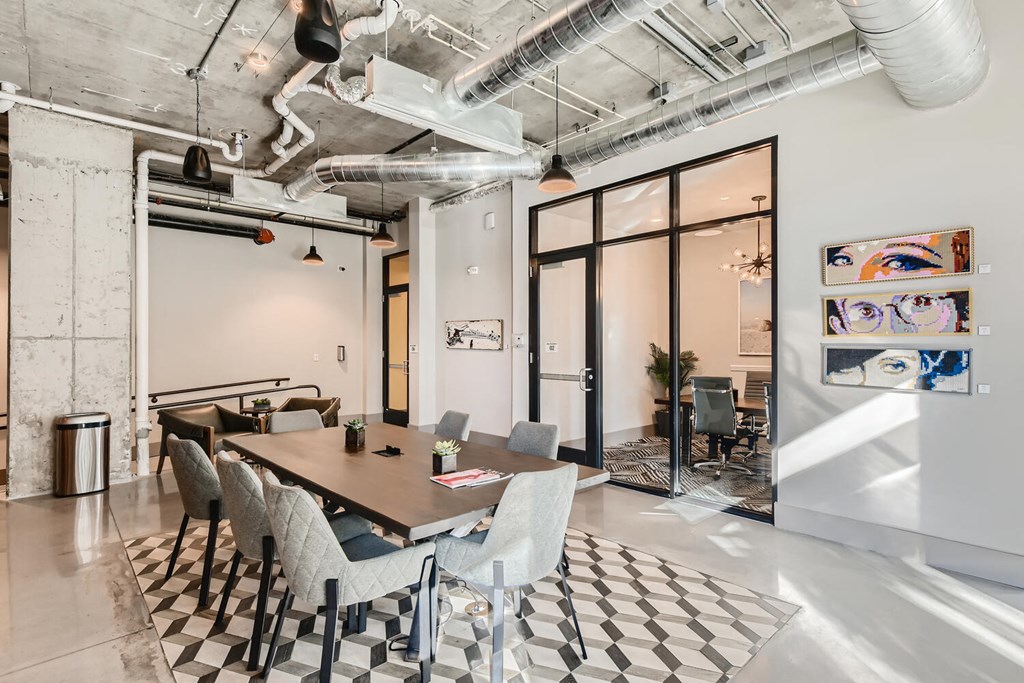 a conference room with a table and chairs and a ceiling fan