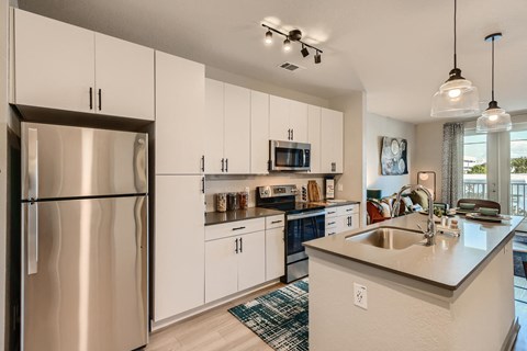a kitchen with stainless steel appliances and white cabinets