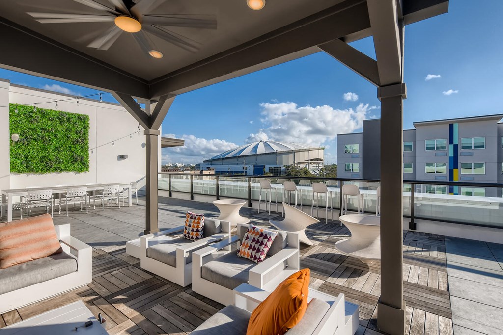 a communal area with couches and tables on a roof