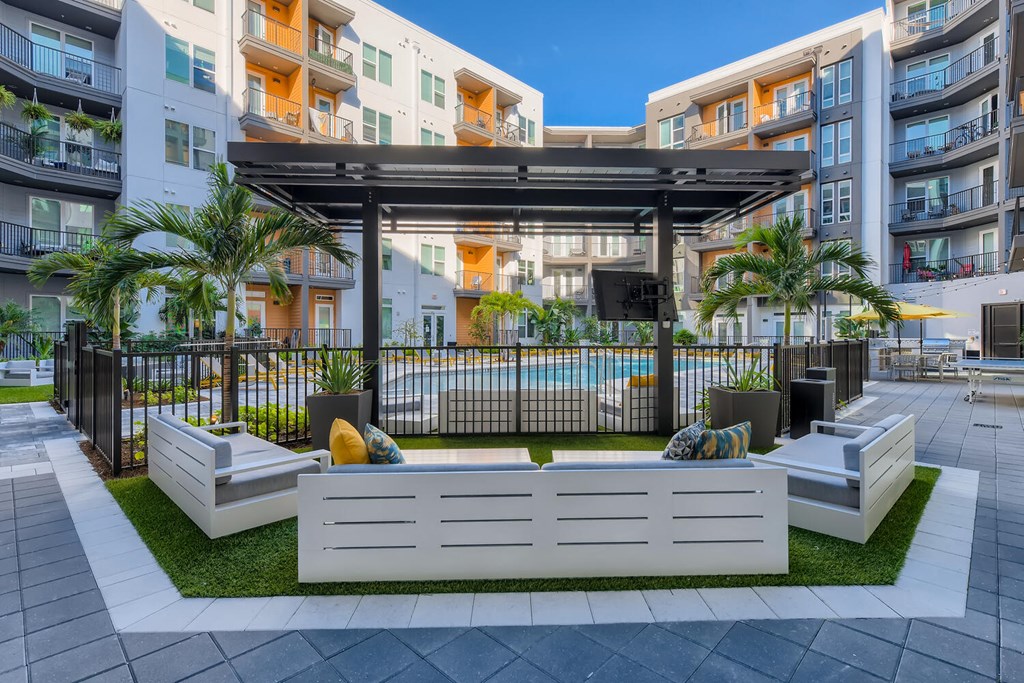 a rendering of an outdoor lounge area with a pool in an apartment building