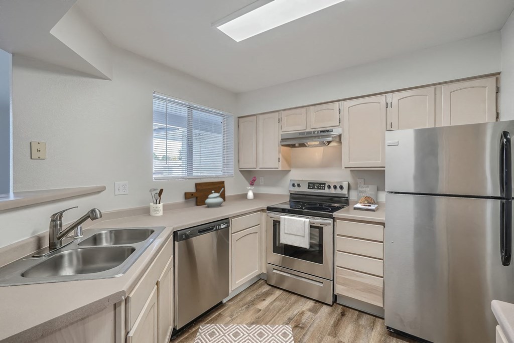 a kitchen with stainless steel appliances and white cabinets