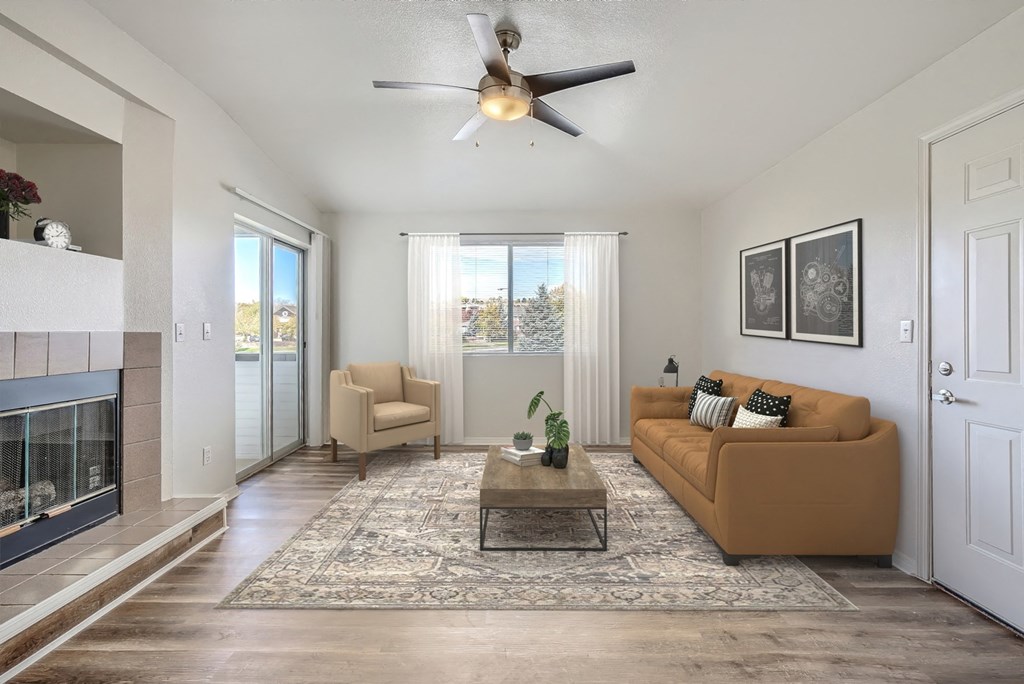 a living room with a ceiling fan and a fireplace