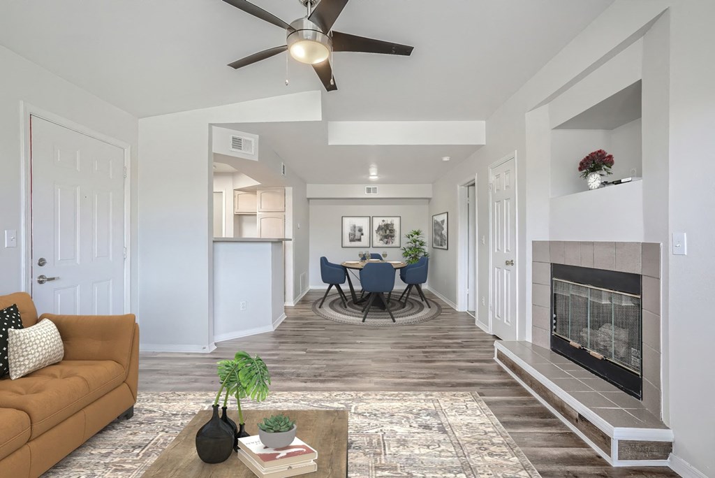 a living room with a fireplace and a table with chairs