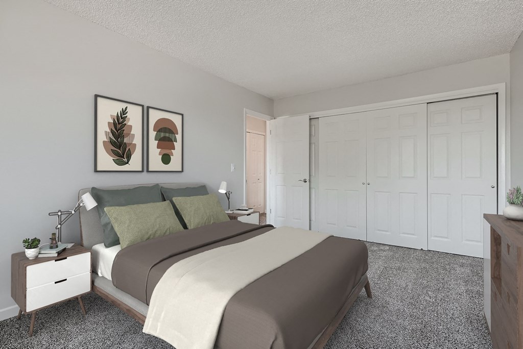 a bedroom with a bed and two paintings on the wall