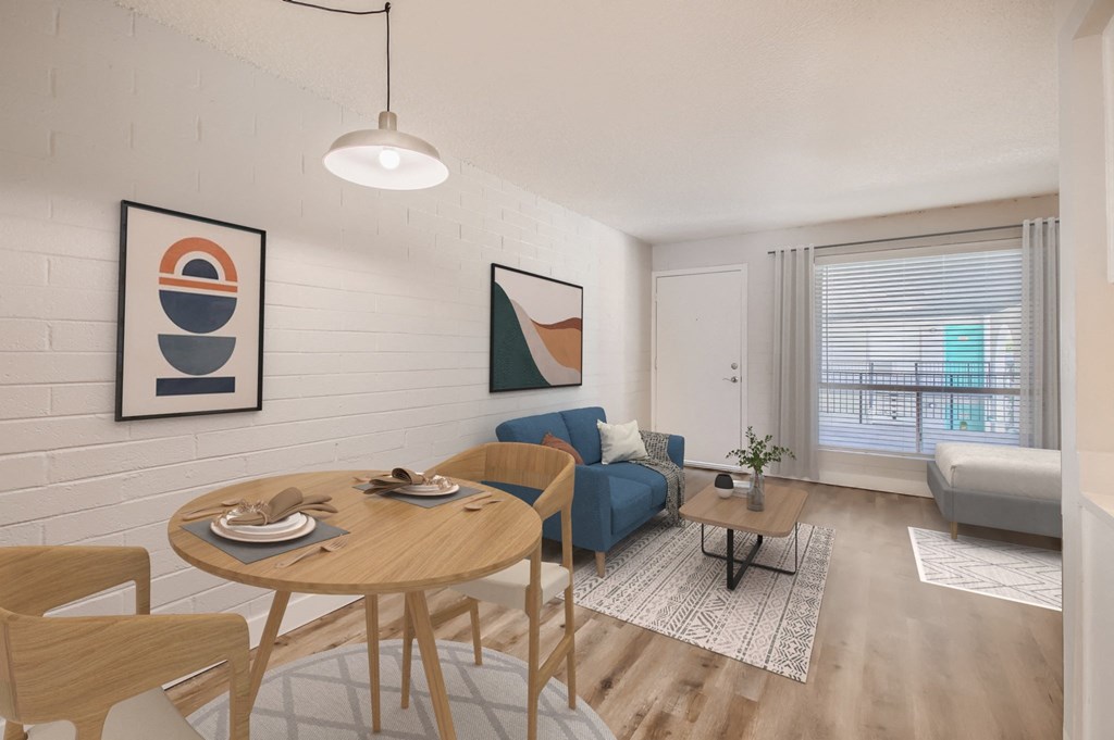 a furnished living room with a blue couch and a wooden coffee table