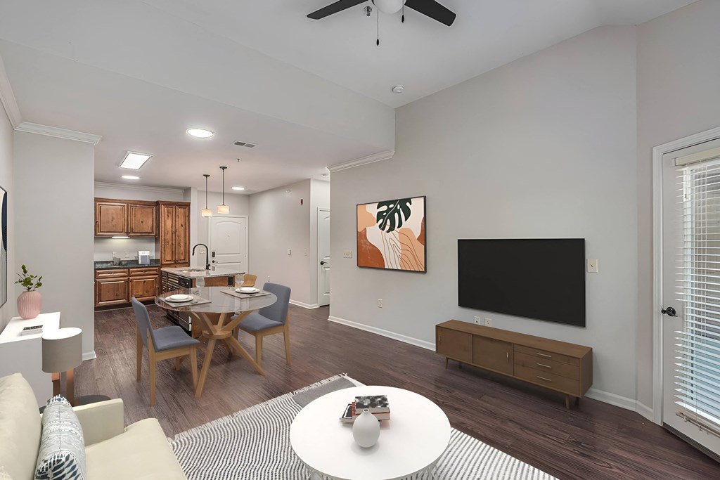 a living room and dining room with a table and a television