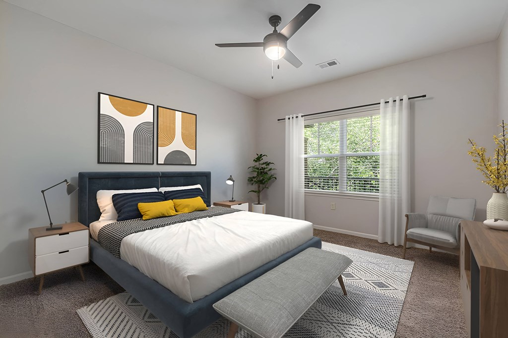 an empty bedroom with a bed and a ceiling fan