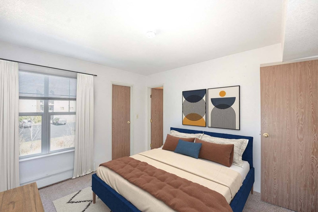 a bedroom with a bed and a window