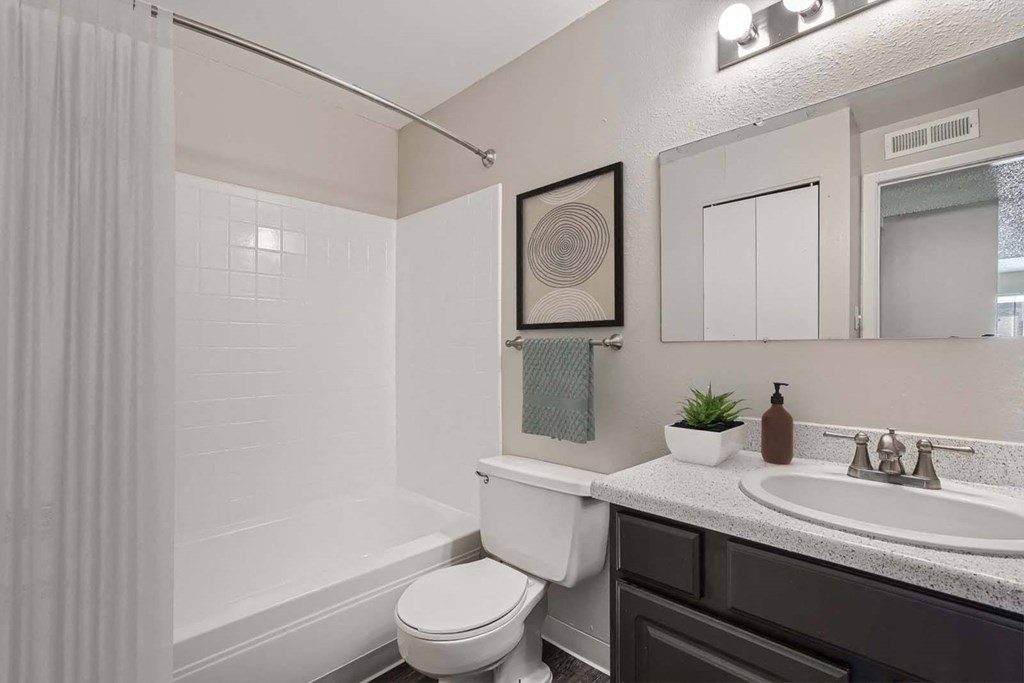 a white bathroom with a sink and a toilet