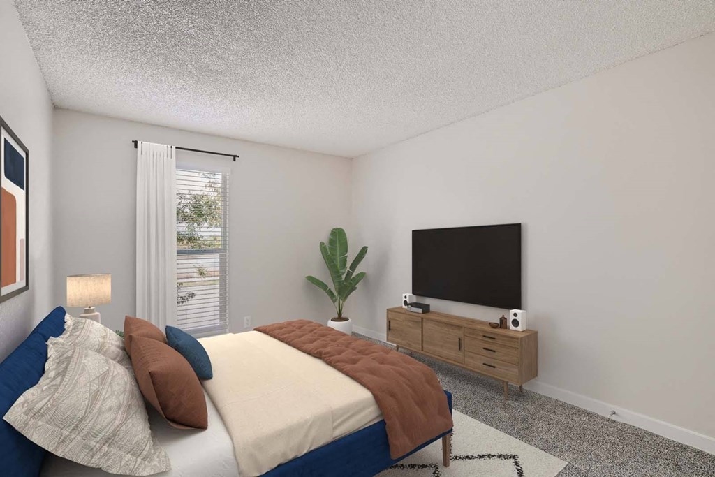 a bedroom with a bed and a tv