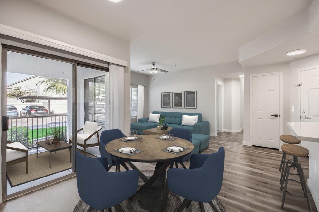 a living room and dining room with a table and chairs