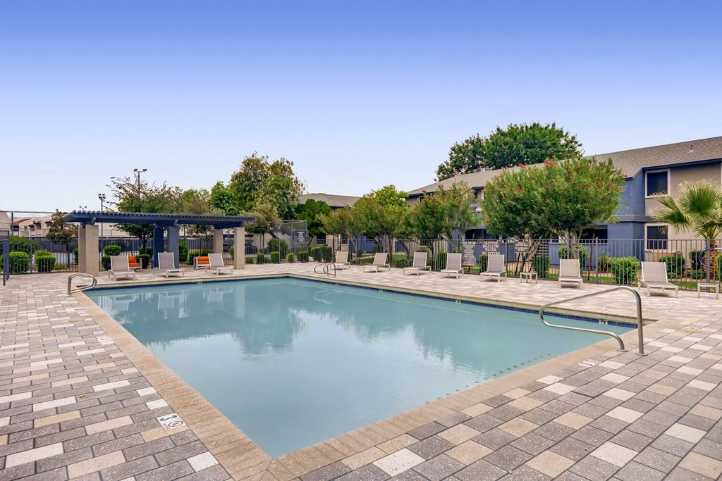 a swimming pool with a building in the background