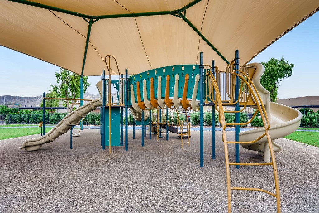 a playground at a park with slides and other playground equipment
