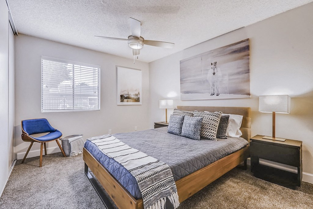 a bedroom with a bed and a ceiling fan