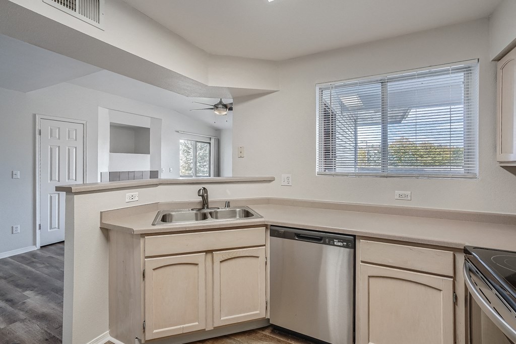 an empty kitchen with a sink and a window