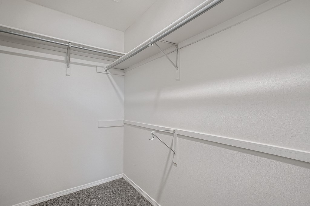 an empty room with white walls and a white closet