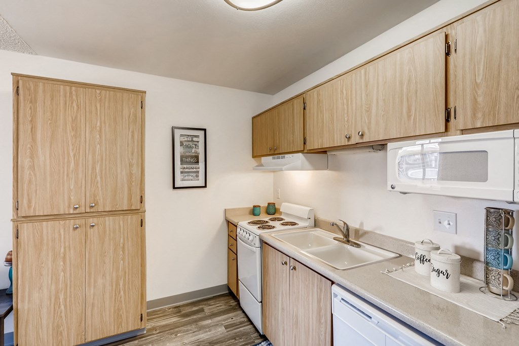 a kitchen with white appliances and wooden cabinets