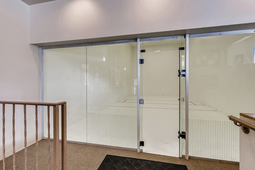 a glass door in a room with a staircase