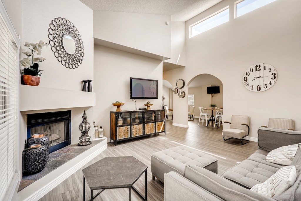 a living room with a fireplace and a large clock on the wall