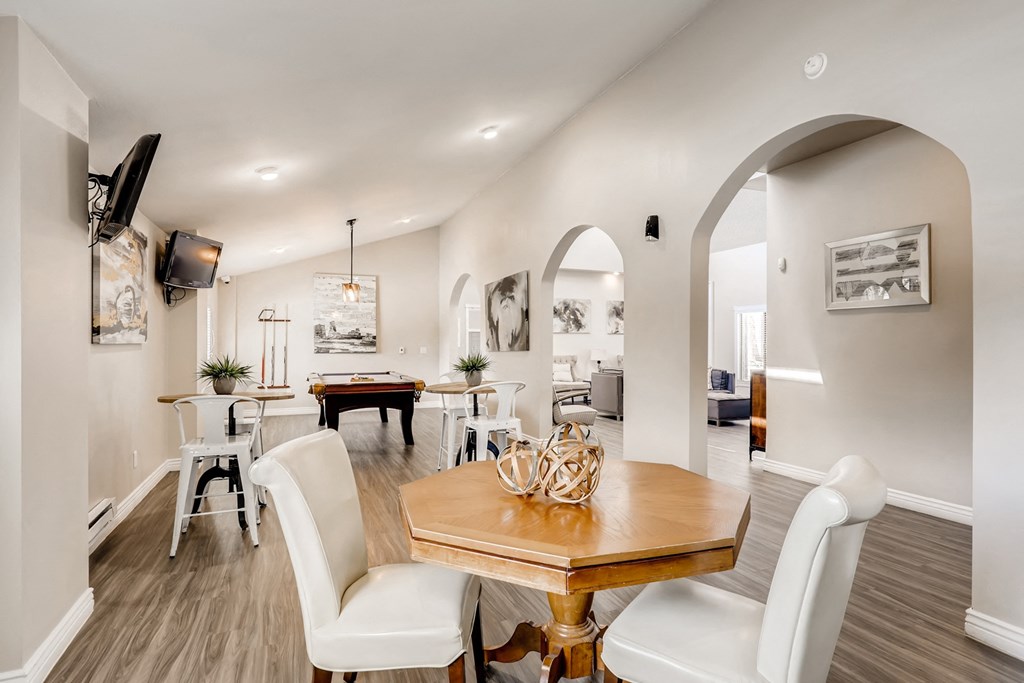 the dining room and living room of a house with a table and chairs