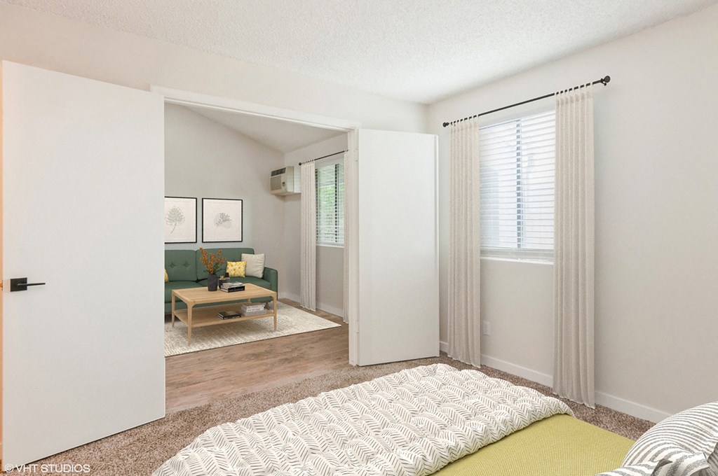 a bedroom with a bed and a living room