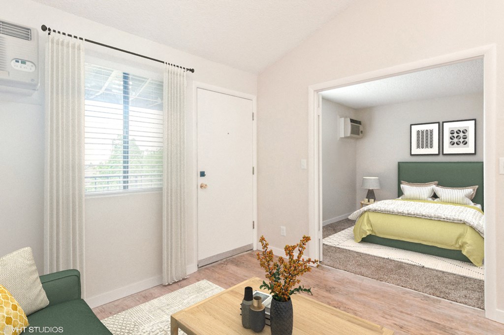 a living room with a bed and a door to a bedroom