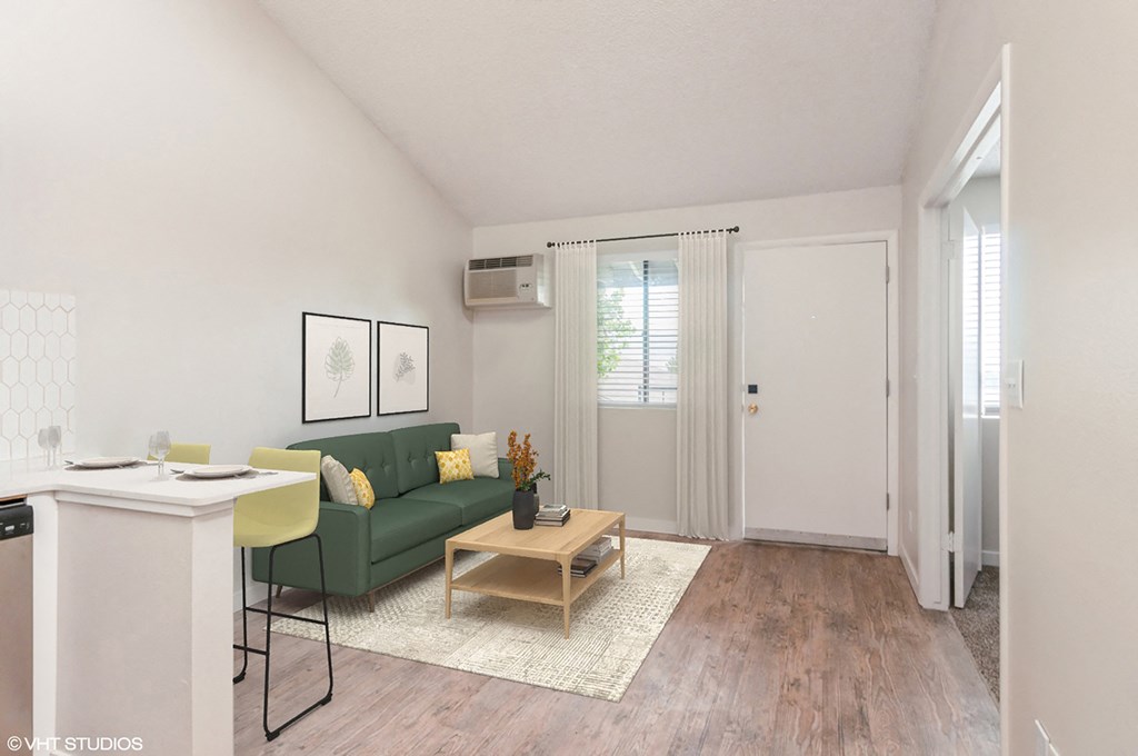 a living room with a green couch and a table