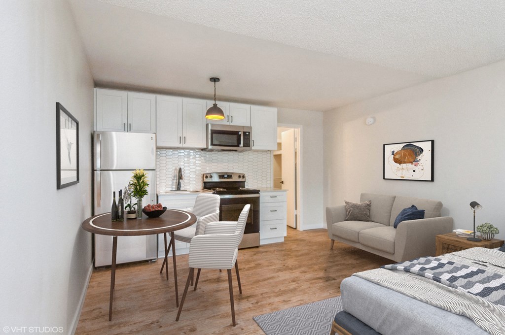 a living room and kitchen with a couch and a table