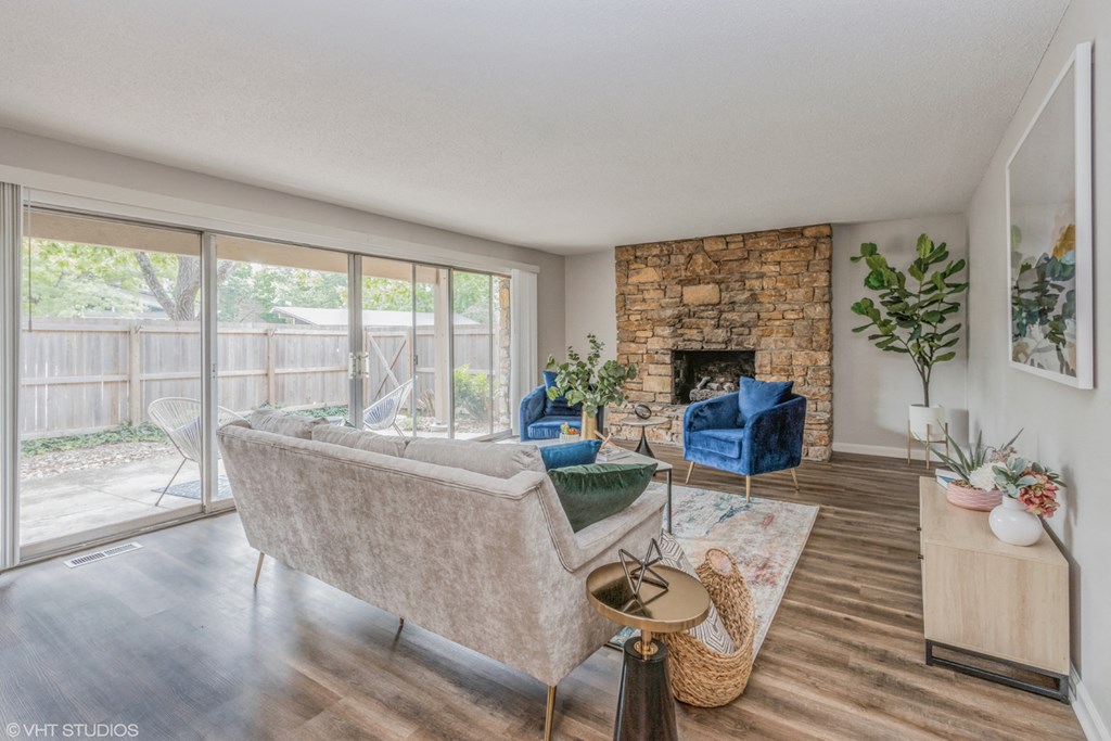 the living room of a house with a stone fireplace