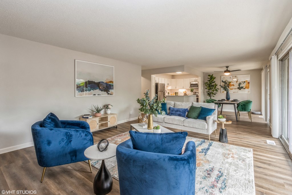 a living room with blue chairs and a couch