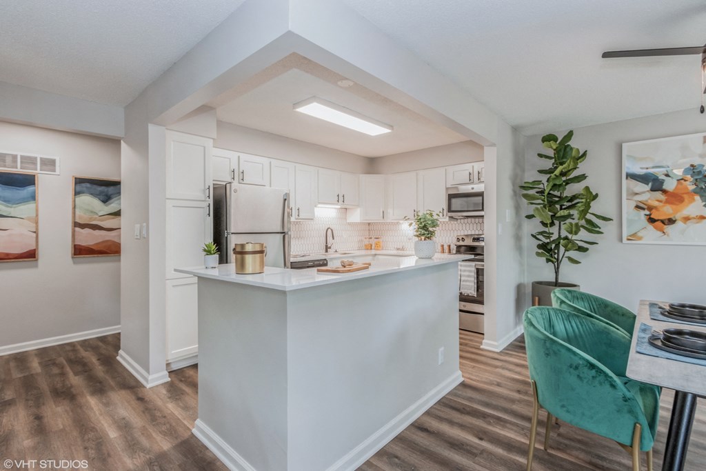 a kitchen with white cabinets and a white counter top