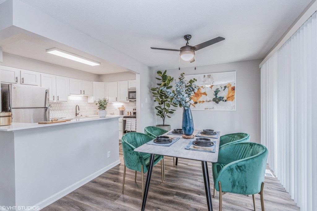 a dining room and kitchen with a table and chairs