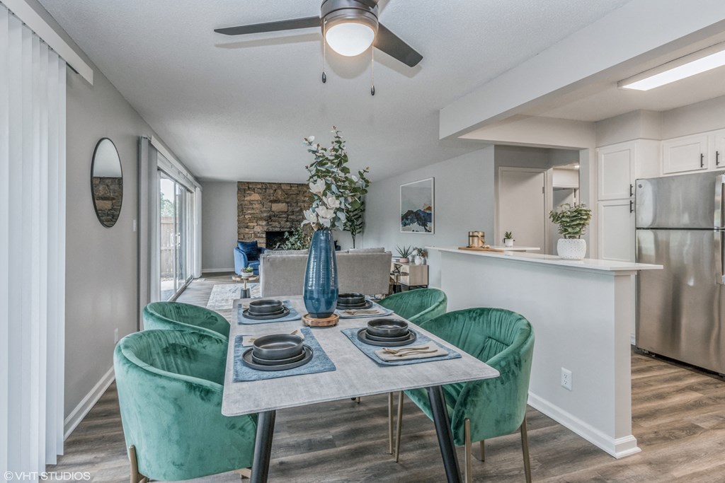 a dining room with a table and chairs and a kitchen
