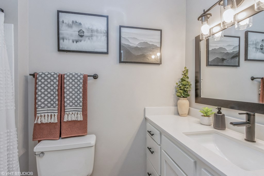 a bathroom with a toilet and a sink and a mirror
