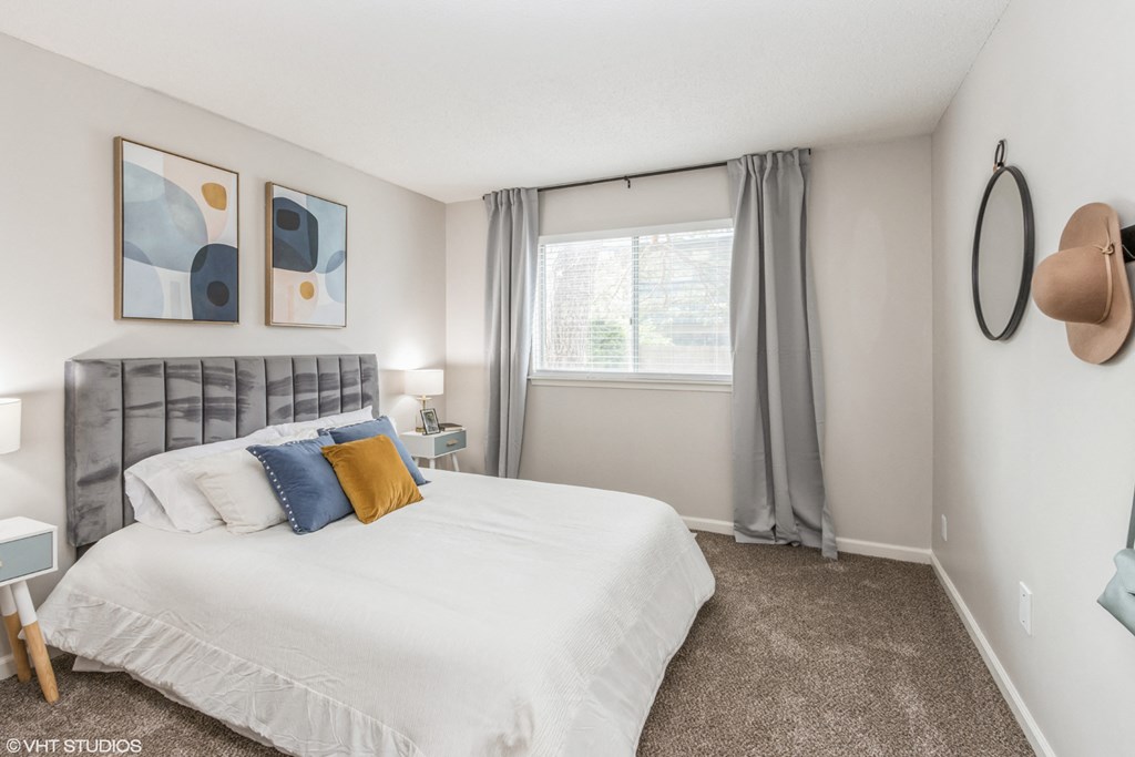 a bedroom with a large bed and a window