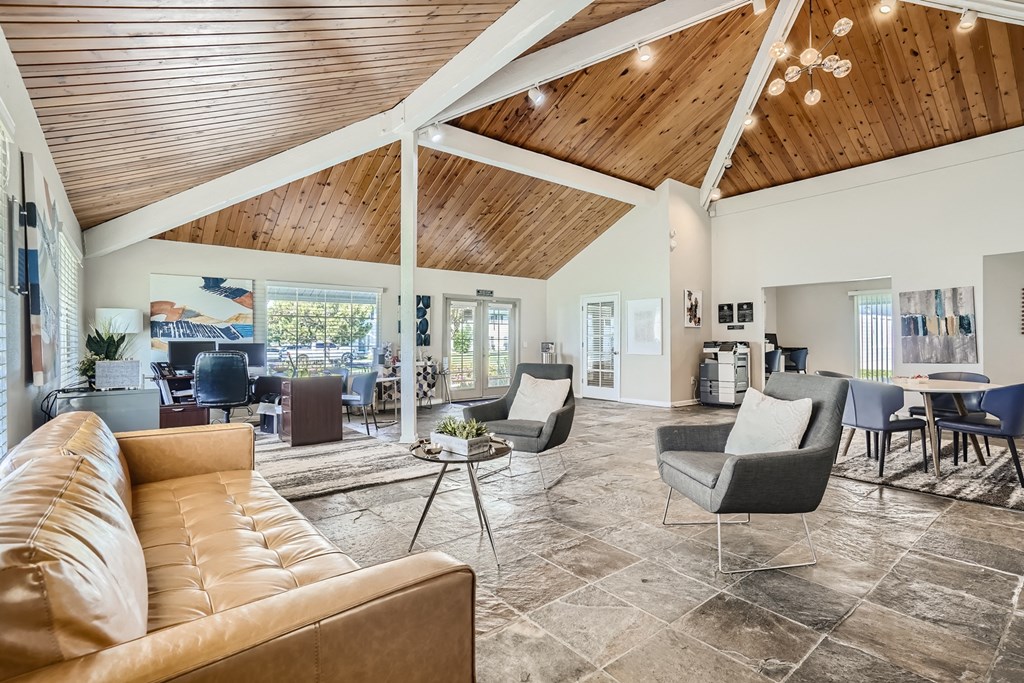 a living room filled with furniture and a large window