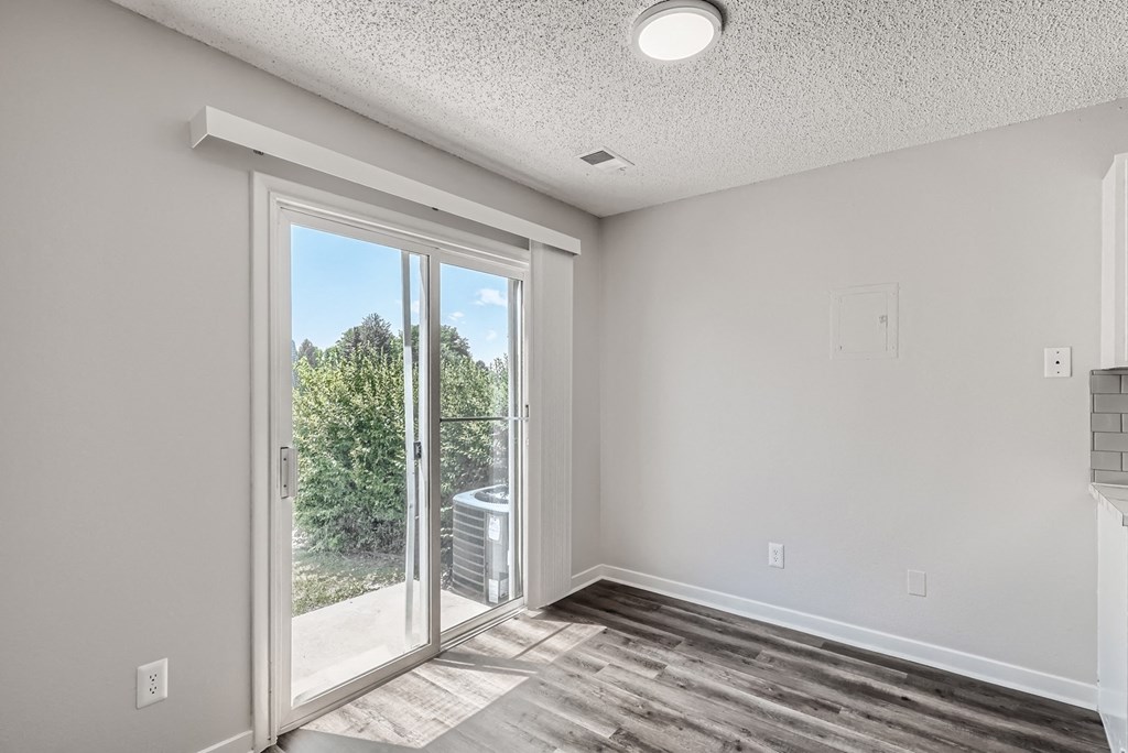 a bedroom with a sliding glass door leading to a balcony