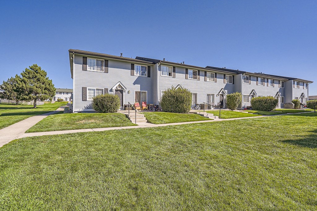 a large white house with a blue sky in the background