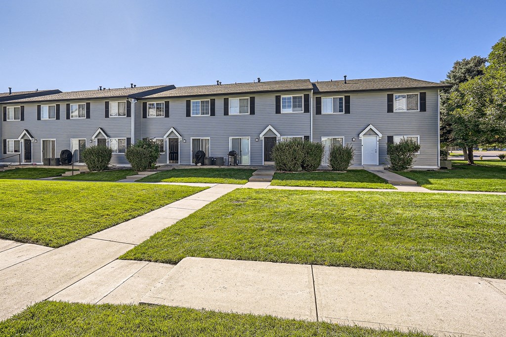 a row of condominiums on a sunny day