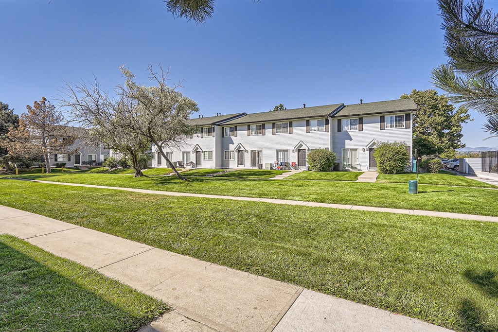 a large white building with trees in front of it