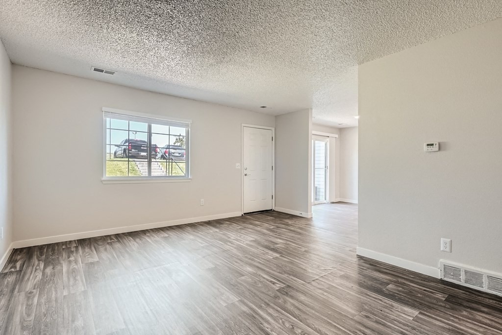 a bedroom with hardwood flooring at the oxford at estonia apartments in san an