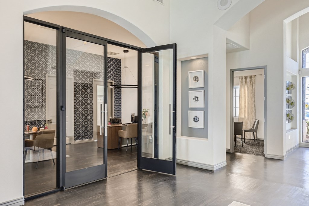 an open living room with glass doors and a dining room in the background