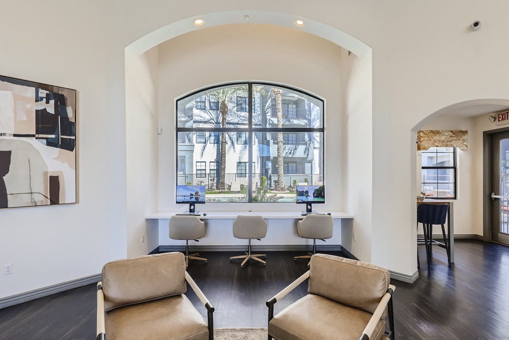 a living room with two chairs and a large window