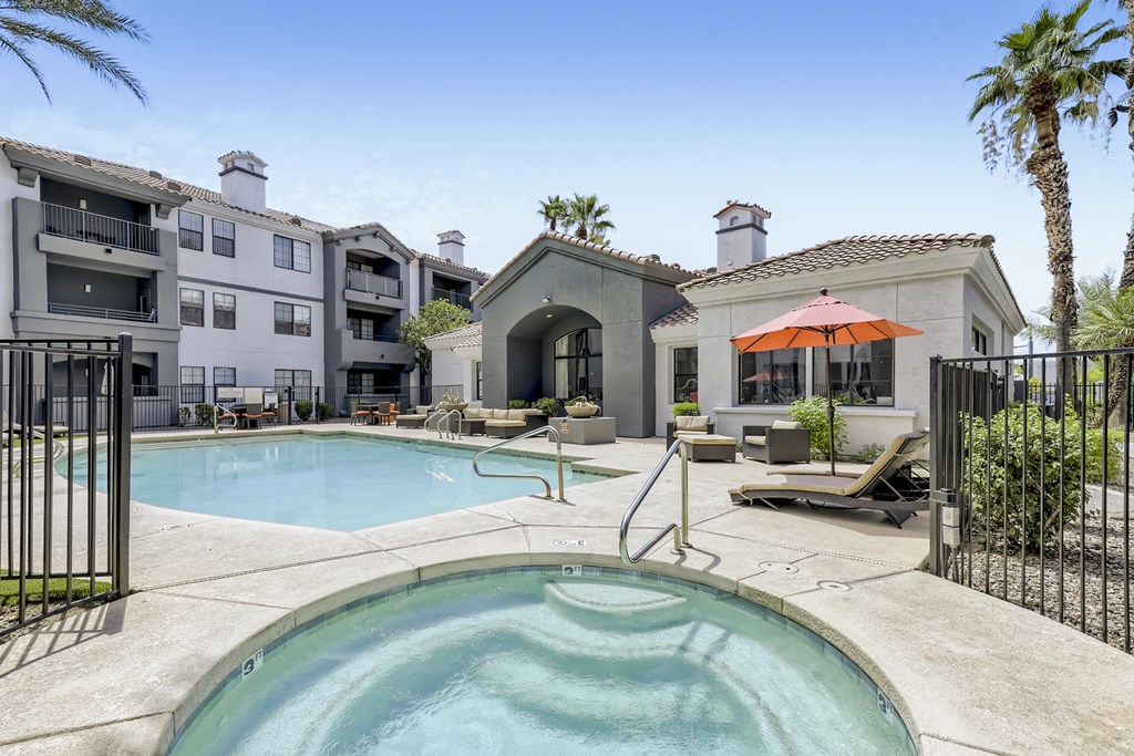 our apartments have a large swimming pool and a patio with chairs