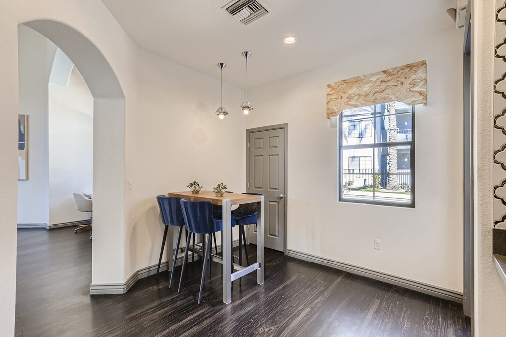 a dining room with a table and chairs and a window