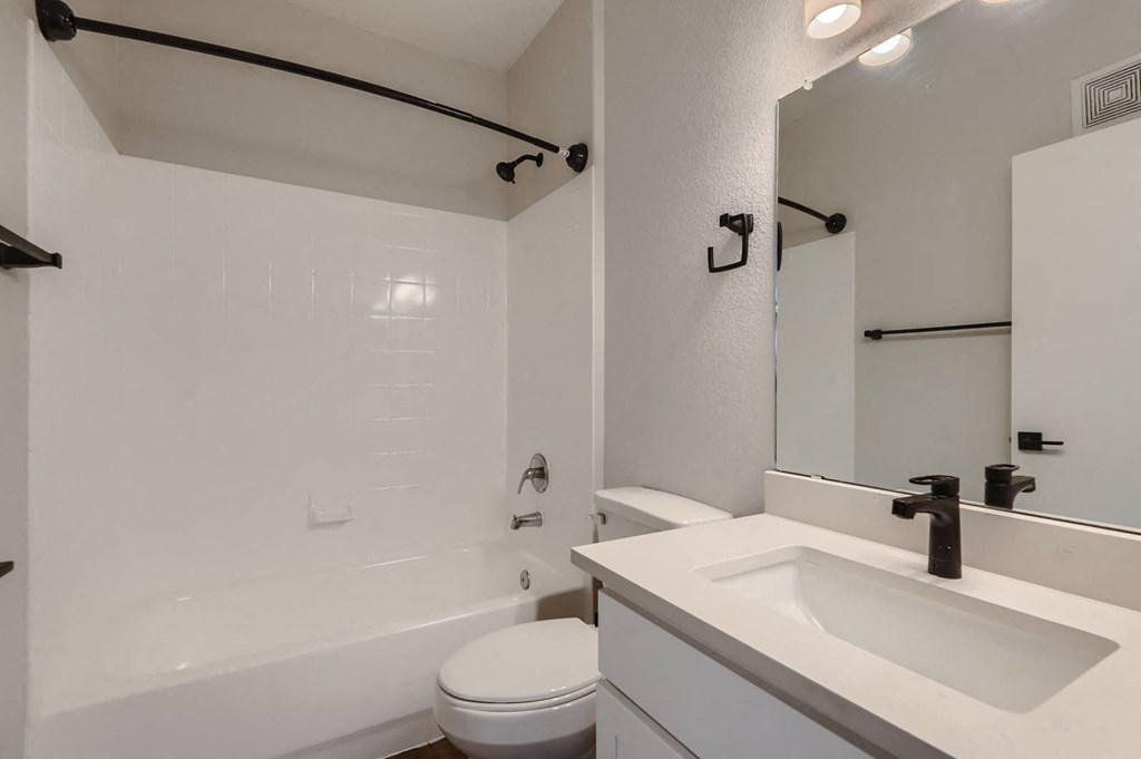 a bathroom with a sink toilet and a tub